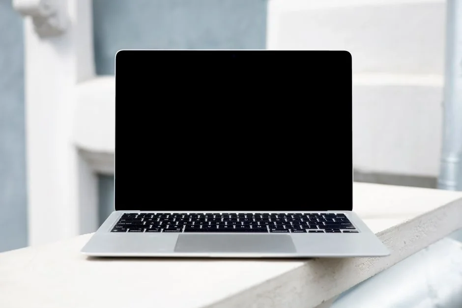 A sleek office desk setup featuring Apple devices: iMac, MacBook, and iPad.
